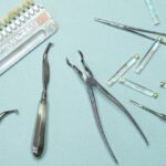 Overhead shot of various dental tools and materials arranged on a blue background.